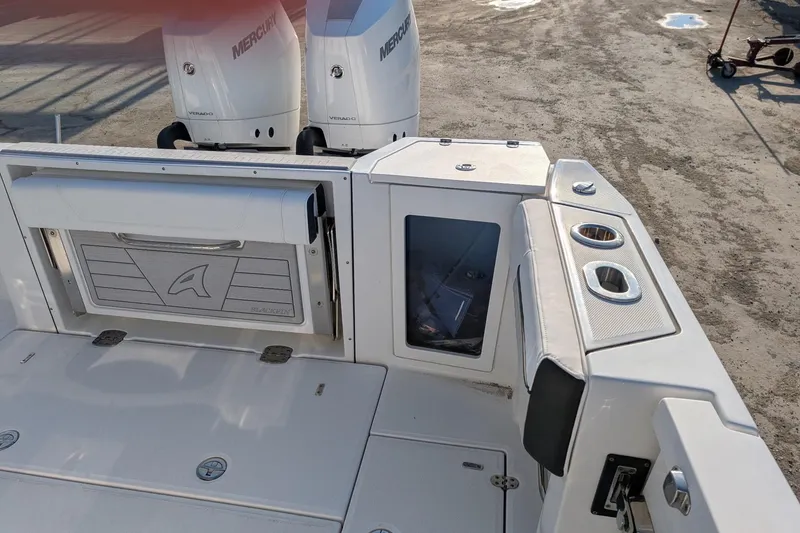Slide: The Image of 2024 Blackfin 332 CC boat deck with Mercury engines and storage compartments. - 14