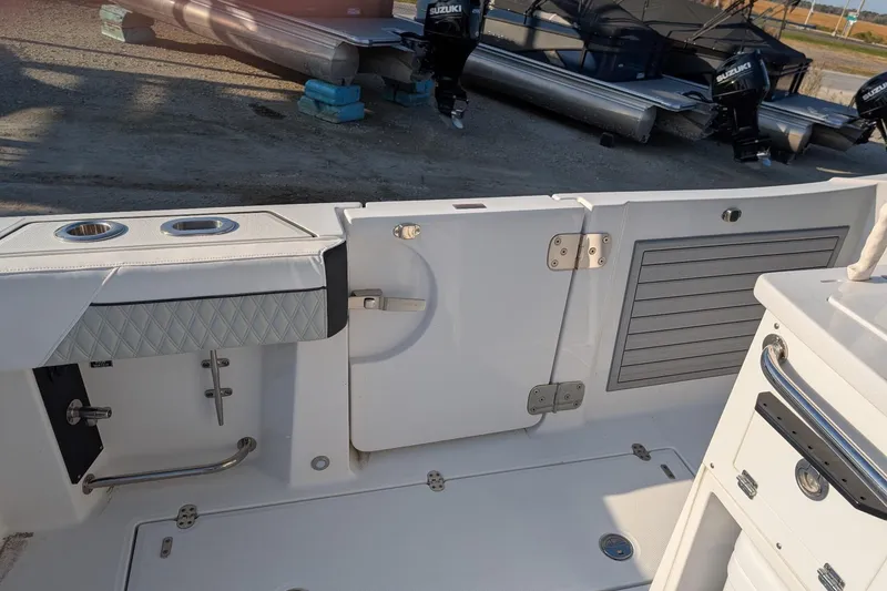 Slide: The Image of 2024 Blackfin 332 CC boat interior with storage compartments and seating. - 15