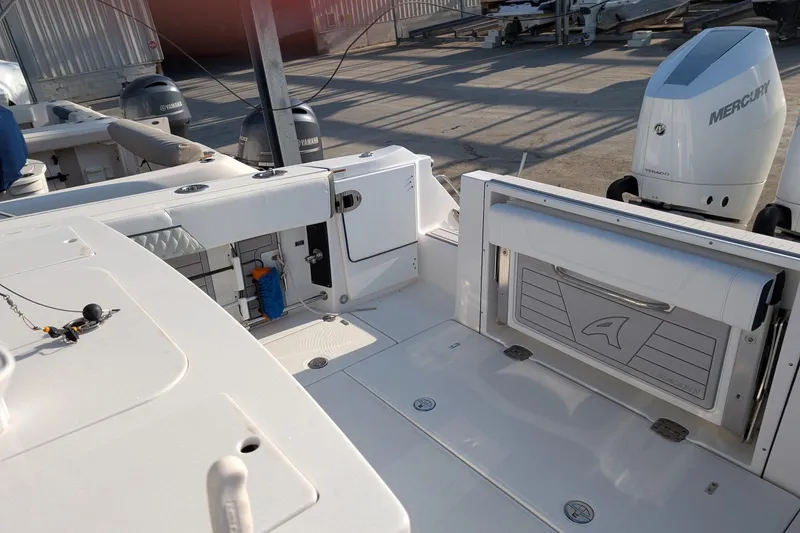 Slide: The Image of 2024 Blackfin 332 CC boat interior with Mercury outboard engine, showcasing spacious deck layout. - 16