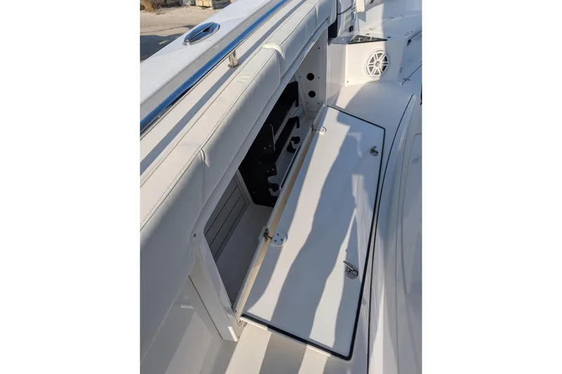 Slide: The Image of 2024 Blackfin 332 CC boat storage compartment with open hatch and speaker. - 20