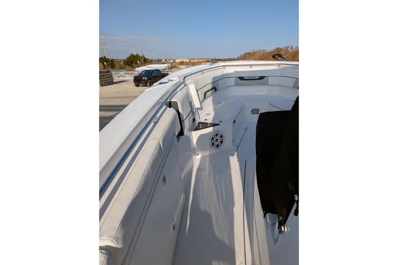 Slide: The Image of 2024 Blackfin 332 CC boat interior with white seating and speaker system. - 21