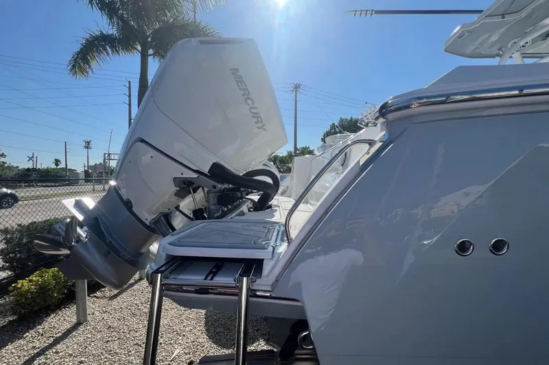 Slide: The Image of 2024 Blackfin 332 CC boat with Mercury outboard engine in sunny outdoor setting. - 26