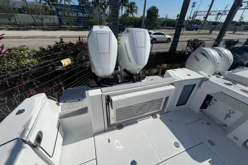 Slide: The Image of 2024 Blackfin 332 CC boat with dual Mercury outboard engines, docked outdoors. - 28