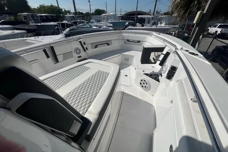 Slide: The Image of 2024 Blackfin 332 CC boat interior with seating and speakers, showcasing modern design and amenities. - 34