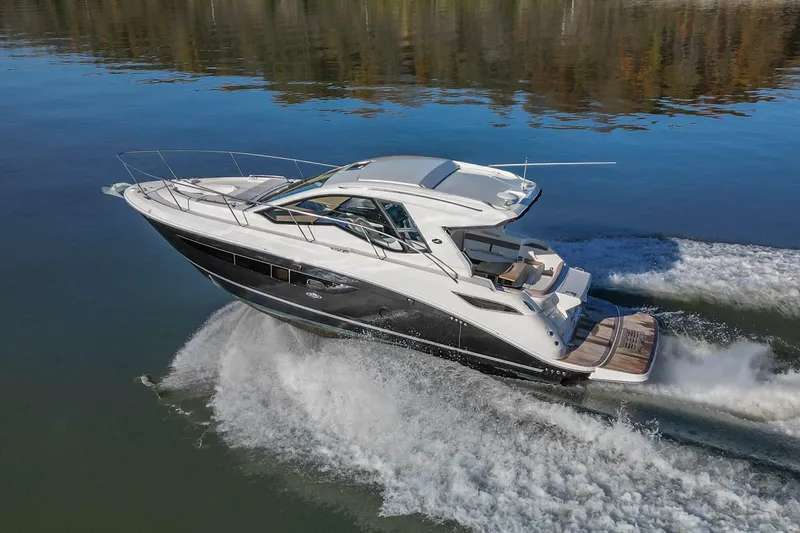 Slide: The Image of 2018 Sea Ray Sundancer 350 Coupe cruising on calm water. - 10