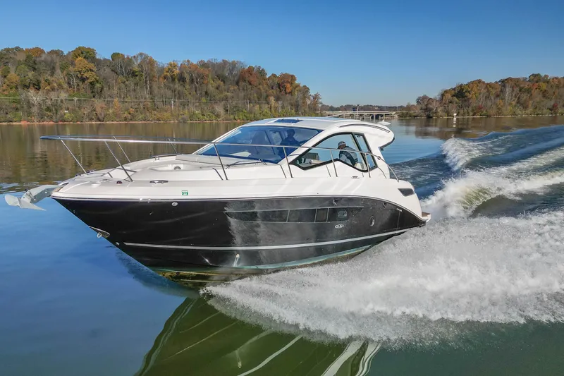 Slide: The Image of 2018 Sea Ray Sundancer 350 Coupe cruising on a serene lake with autumn foliage. - 12