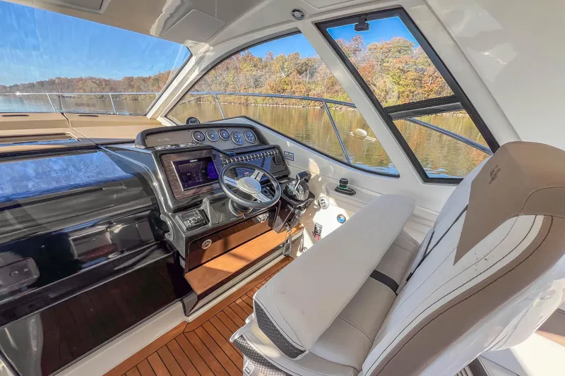 Slide: The Image of Interior of 2018 Sea Ray Sundancer 350 Coupe, featuring helm and luxurious seating. - 14