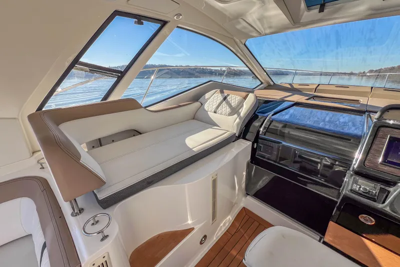 Slide: The Image of 2018 Sea Ray Sundancer 350 Coupe interior with luxurious seating and panoramic windows. - 16