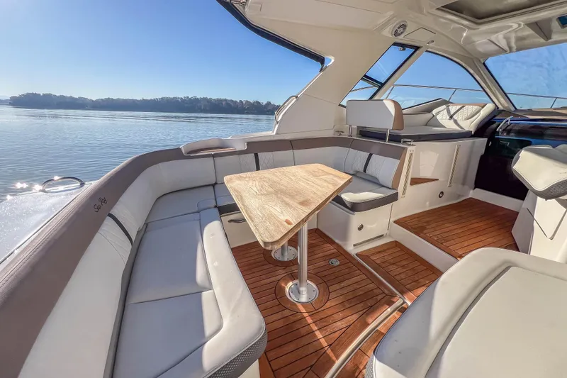 Slide: The Image of 2018 Sea Ray Sundancer 350 Coupe interior with elegant seating and wooden flooring. - 17