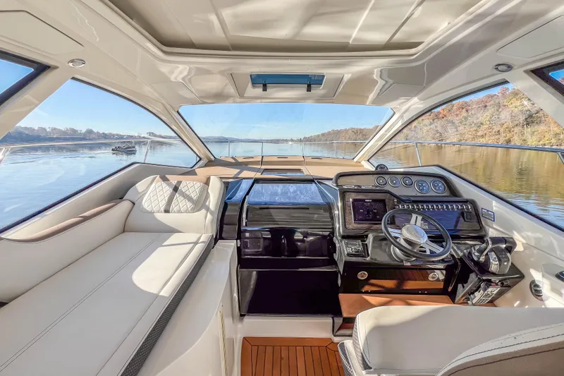 Slide: The Image of 2018 Sea Ray Sundancer 350 Coupe interior with luxurious helm and panoramic water view. - 25