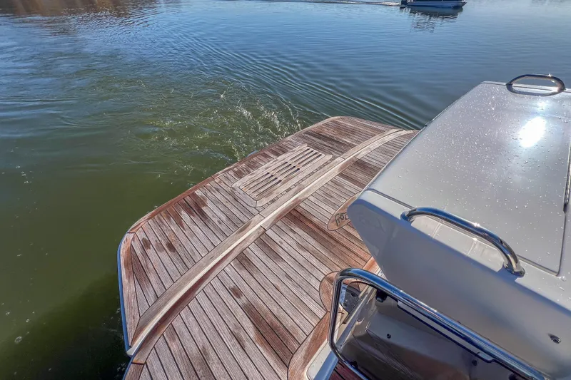 Slide: The Image of 2018 Sea Ray Sundancer 350 Coupe with wooden deck on calm water. - 26