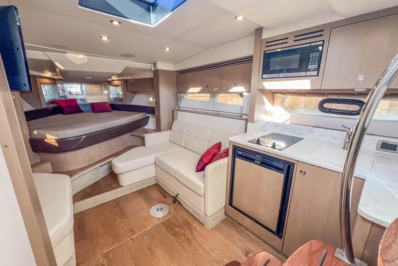Slide: The Image of Luxurious interior of 2018 Sea Ray Sundancer 350 Coupe with modern kitchen and cozy seating. - 28
