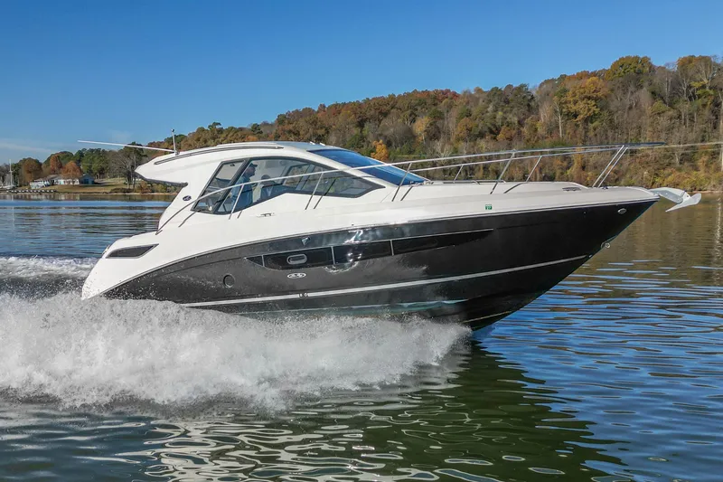 Slide: The Image of 2018 Sea Ray Sundancer 350 Coupe cruising on a scenic lake. - 3