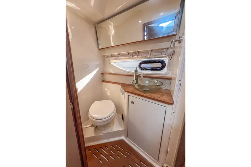 Slide: The Image of Luxurious bathroom in 2018 Sea Ray Sundancer 350 Coupe with modern fixtures and wood accents. - 30