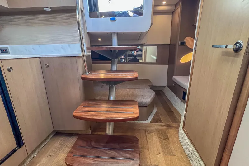 Slide: The Image of Interior of 2018 Sea Ray Sundancer 350 Coupe with wooden steps and modern design. - 31