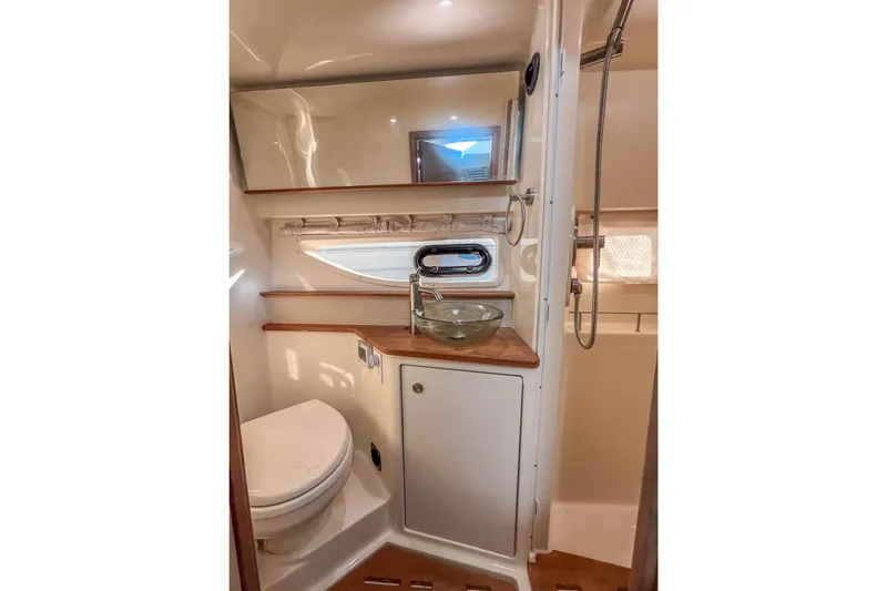 Slide: The Image of 2018 Sea Ray Sundancer 350 Coupe bathroom with modern fixtures and wood accents. - 34