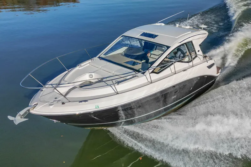 Slide: The Image of 2018 Sea Ray Sundancer 350 Coupe cruising on calm waters. - 9