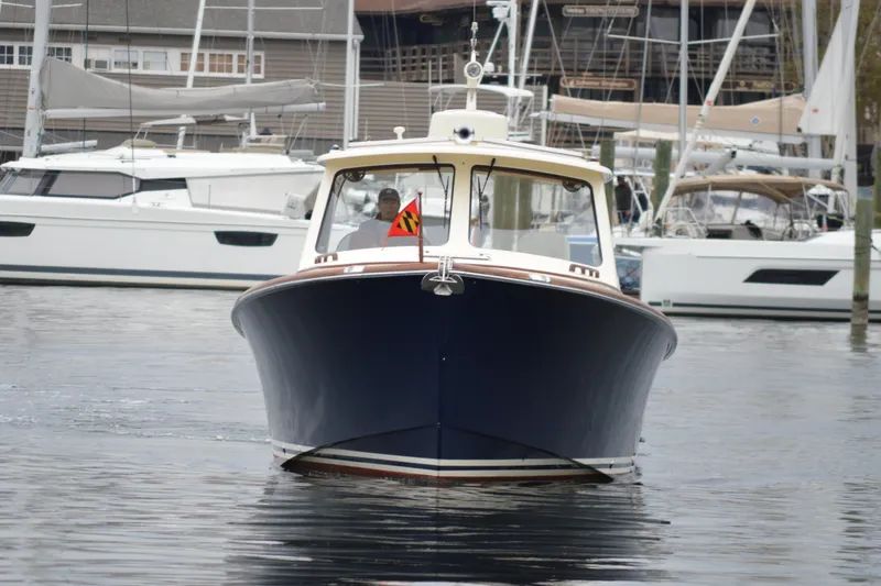 Slide: The Image of 2009 Hinckley 37 boat docked in marina, surrounded by sailboats. - 1