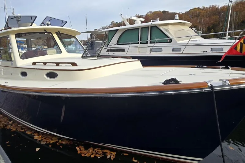 Slide: The Image of 2009 Hinckley 37 boat docked, featuring classic design and sleek lines. - 10