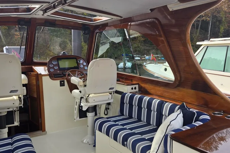 Slide: The Image of Interior of a 2009 Hinckley 37 boat with striped seating and wooden accents. - 15