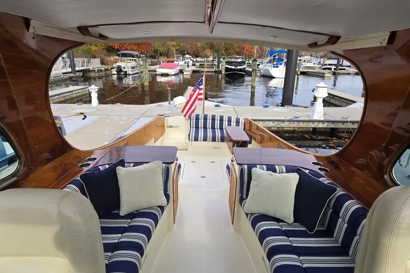 Slide: The Image of Luxurious 2009 Hinckley 37 yacht interior with striped seating and marina view. - 17