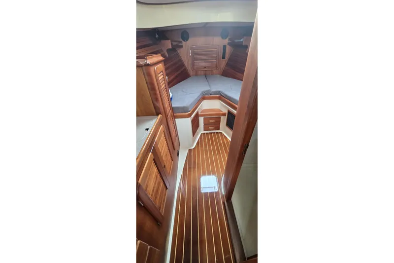 Slide: The Image of Interior of 2009 Hinckley 37 yacht with wooden finish and cozy sleeping area. - 23