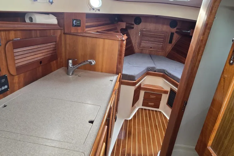 Slide: The Image of Interior of 2009 Hinckley 37 yacht with wooden cabinetry and cozy sleeping area. - 24