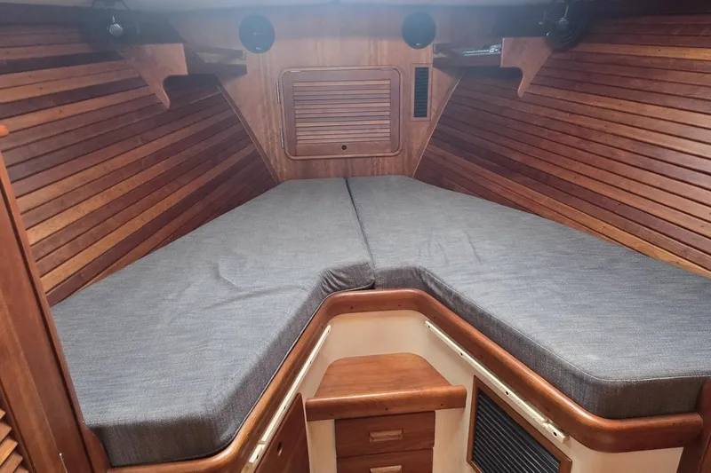 Slide: The Image of Interior cabin of 2009 Hinckley 37 boat with wooden paneling and cushioned seating. - 25
