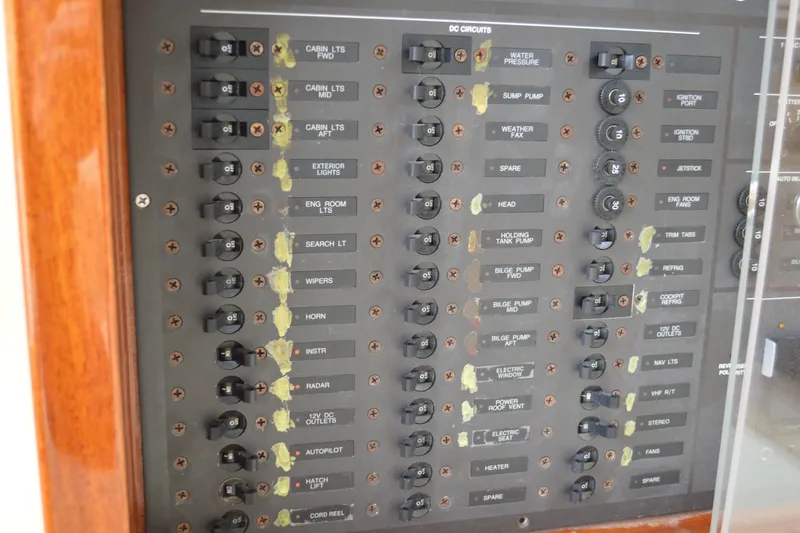 Slide: The Image of Electrical control panel on a 2009 Hinckley 37 boat, featuring various labeled switches. - 28