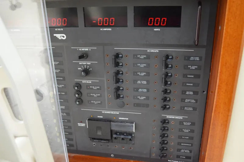 Slide: The Image of Electrical control panel on a 2009 Hinckley 37 boat, featuring AC circuits and meters. - 29