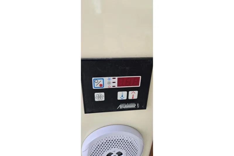 Slide: The Image of Control panel on a 2009 Hinckley 37 boat, featuring temperature and fan settings. - 30