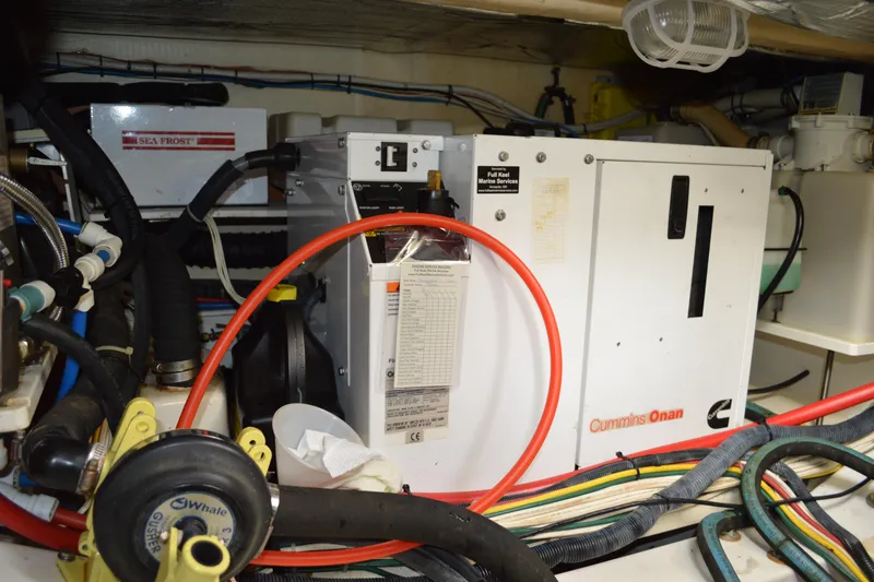 Slide: The Image of Engine room of 2009 Hinckley 37 with Cummins Onan generator and Sea Frost system. - 31