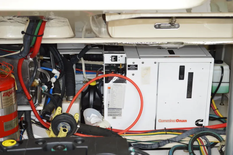 Slide: The Image of Engine room of a 2009 Hinckley 37 with Cummins Onan generator and various cables. - 32