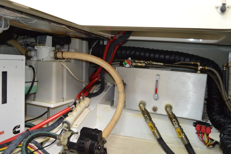 Slide: The Image of Engine compartment of a 2009 Hinckley 37 boat, showcasing hoses and mechanical components. - 34