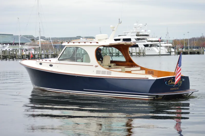 Slide: The Image of 2009 Hinckley 37 yacht with American flag, docked in a marina. - 4