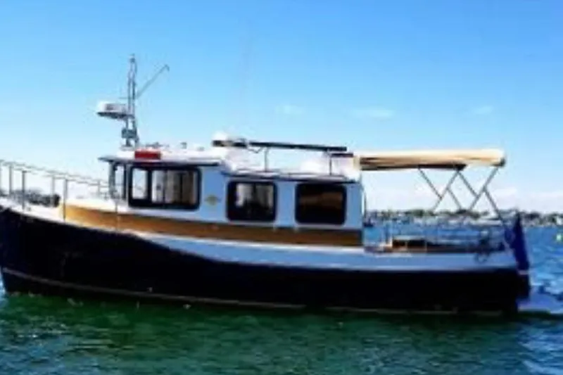 The Image of 2014 Ranger Tugs R-27 boat on water under clear blue sky. - 0