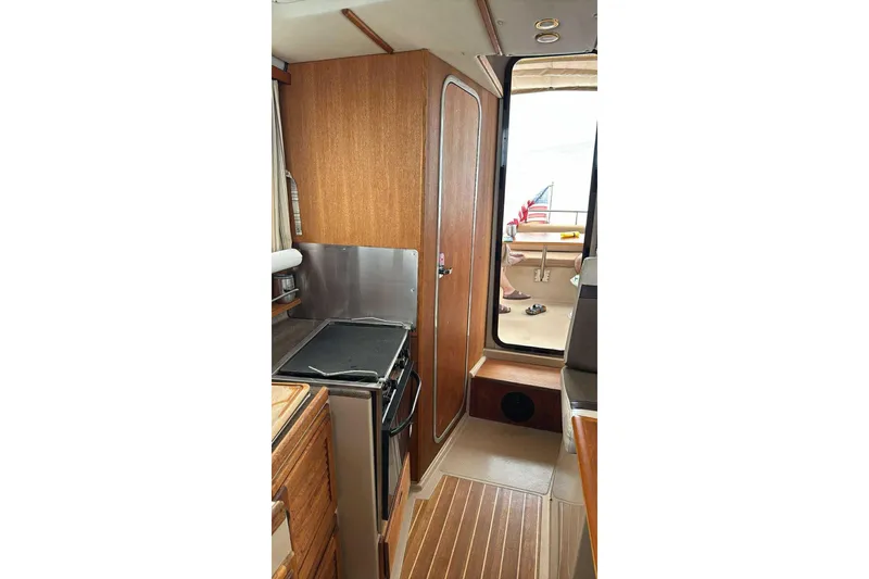 Slide: The Image of Interior view of 2014 Ranger Tugs R-27, featuring a compact kitchen area. - 12