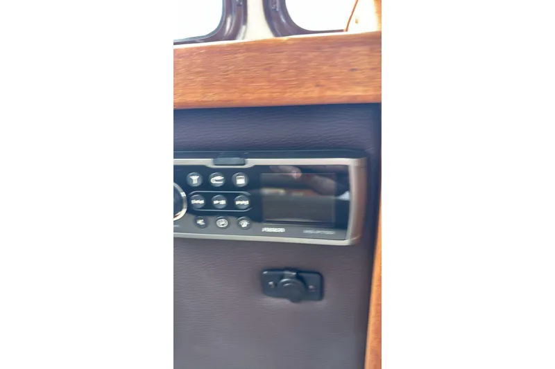 Slide: The Image of Control panel inside 2014 Ranger Tugs R-27 boat, featuring buttons and display. - 15