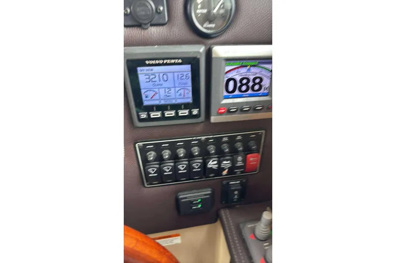 Slide: The Image of Dashboard of 2014 Ranger Tugs R-27 with navigation and control panels. - 17