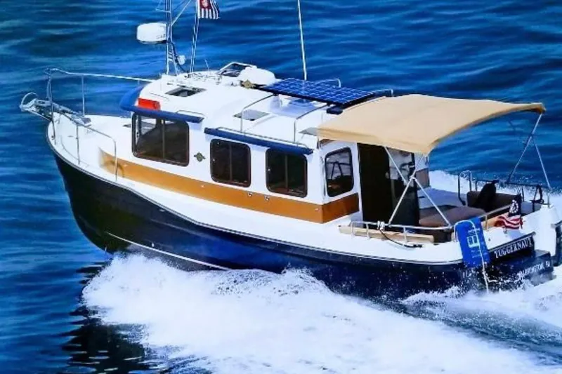 Slide: The Image of 2014 Ranger Tugs R-27 cruising on blue ocean waters. - 3