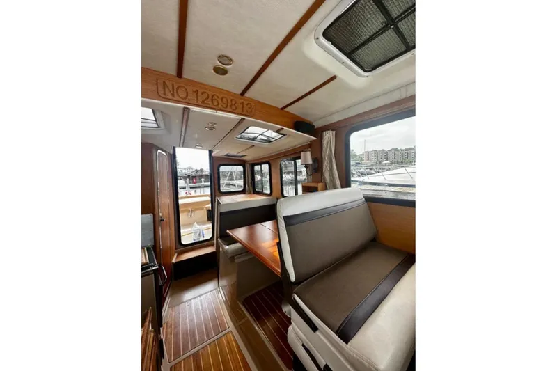 Slide: The Image of Interior of 2014 Ranger Tugs R-27 boat with seating and wooden accents. - 8