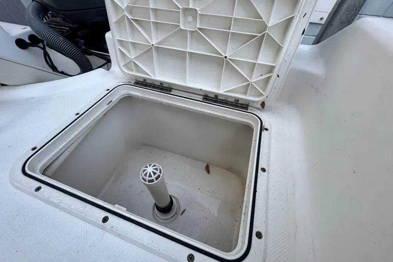 Slide: The Image of Open storage compartment on a 2006 Century 2001 Center Console boat. - 11