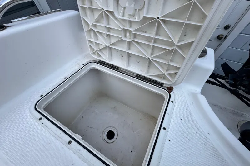 Slide: The Image of Open storage compartment on a 2006 Century 2001 Center Console boat. - 12