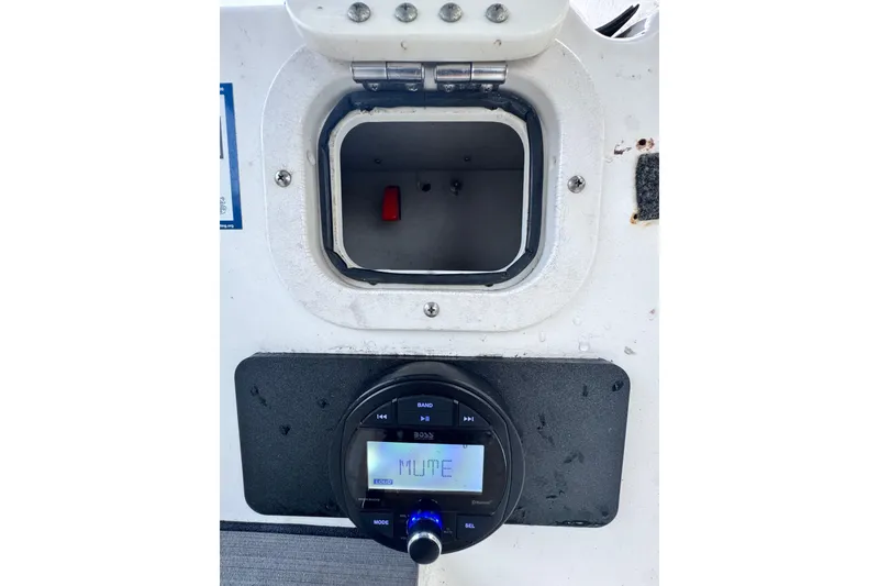 Slide: The Image of 2006 Century 2001 Center Console boat dashboard with audio system and storage compartment. - 15