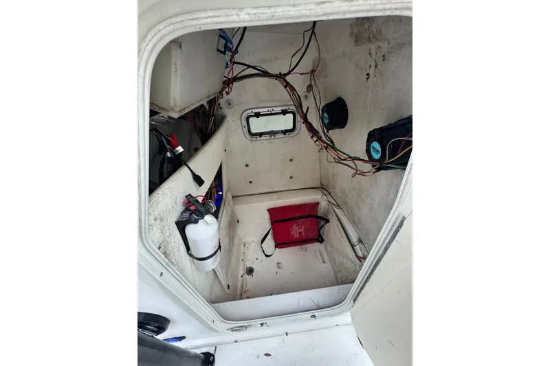 Slide: The Image of Interior of a 2006 Century 2001 Center Console boat, showing wiring and equipment. - 16
