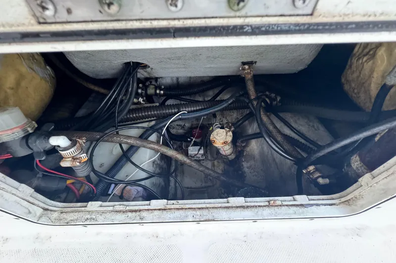 Slide: The Image of Engine compartment of a 2006 Century 2001 Center Console boat, showing hoses and wiring. - 18