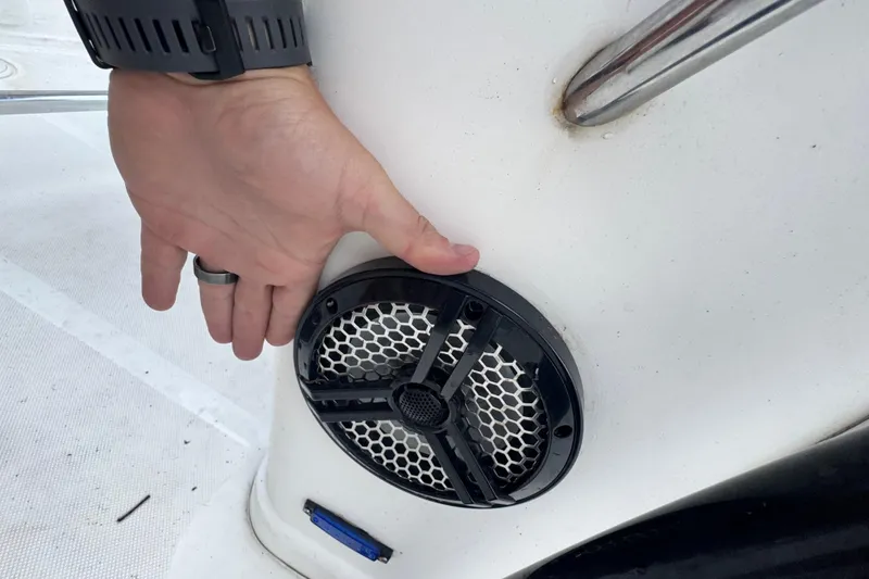 Slide: The Image of Hand adjusting speaker on 2006 Century 2001 Center Console boat. - 19