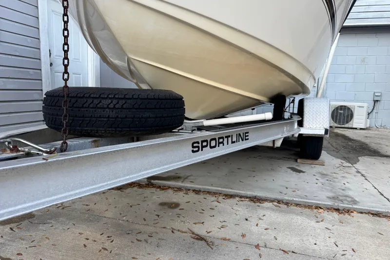 Slide: The Image of 2006 Century 2001 Center Console boat on Sportline trailer, parked on concrete. - 25