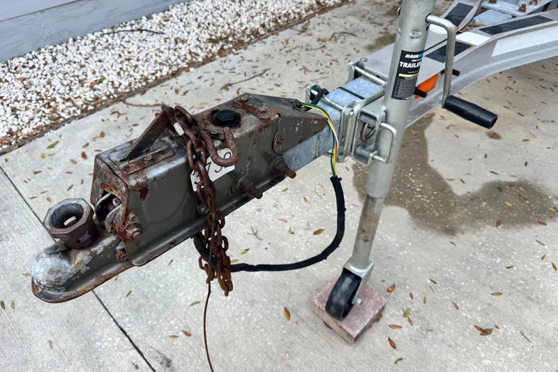 Slide: The Image of Trailer hitch of a 2006 Century 2001 Center Console boat on concrete. - 26