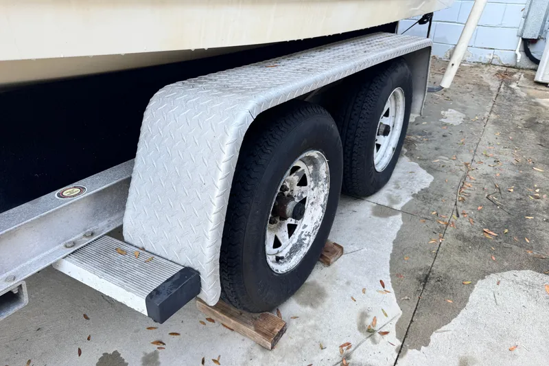 Slide: The Image of Trailer wheels of a 2006 Century 2001 Center Console boat on concrete. - 28